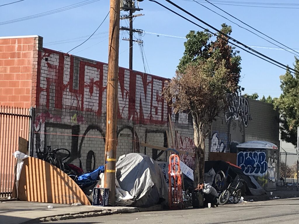 A photo of a street near the Paloma St. warehouse, lined with tents of homeless people