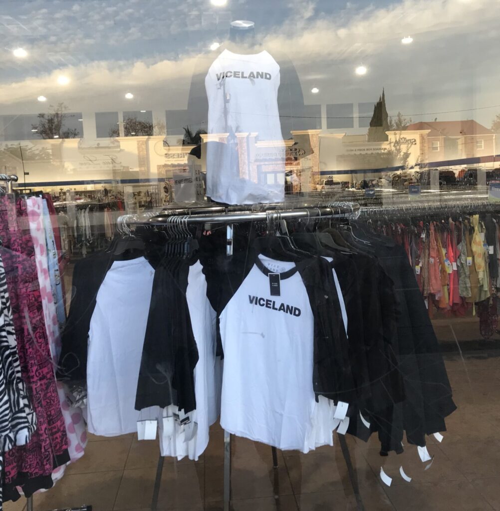 A photo of a rack at a Goodwill store holding "Viceland" branded shirts