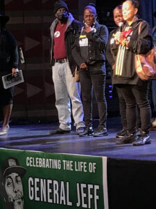 A photo of Abdullah speaking at the celebration of life event for Page