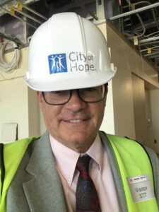 A photo of Sullivan wearing a hard hat at City of Hope's construction site